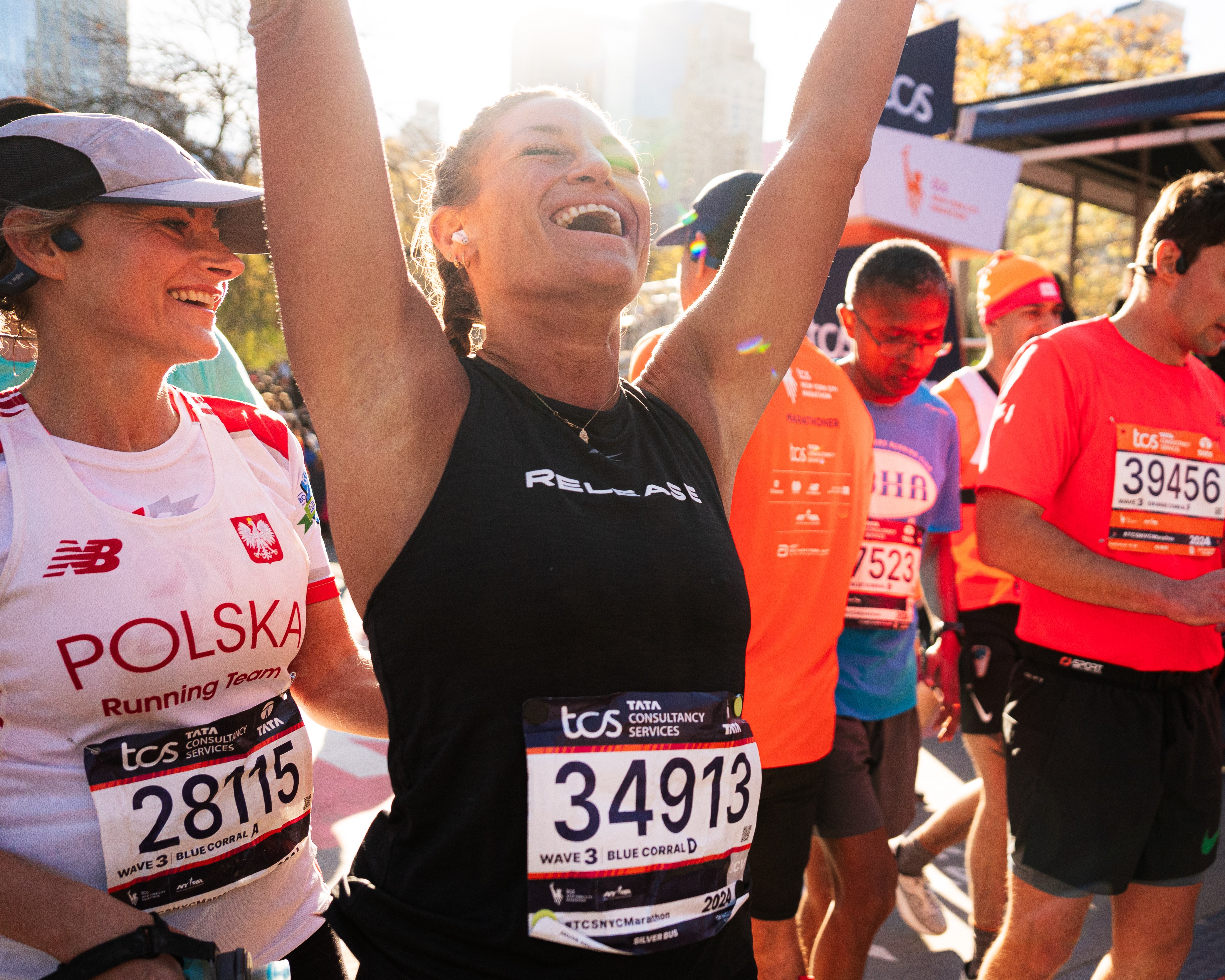 Runners celebrating at the TCS New York City Marathon finish line