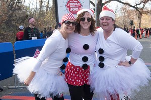 Runners in holiday costumes at the NYRR Jingle Bell Jog