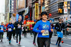 Runner smiling in the 2017 NYRR United Airlines New York City Half Marathon