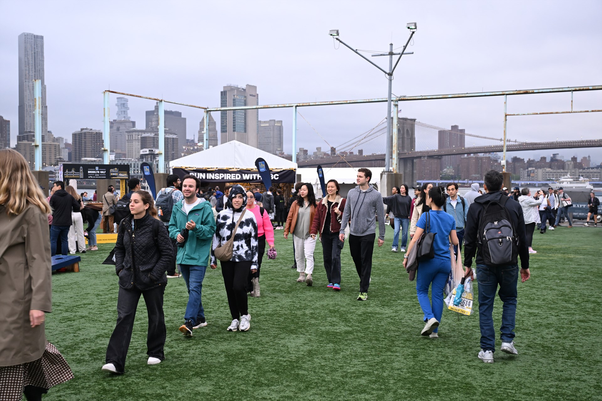 People walking around Pier 2 at the 2025 RBC Brooklyn Half Pre-Party
