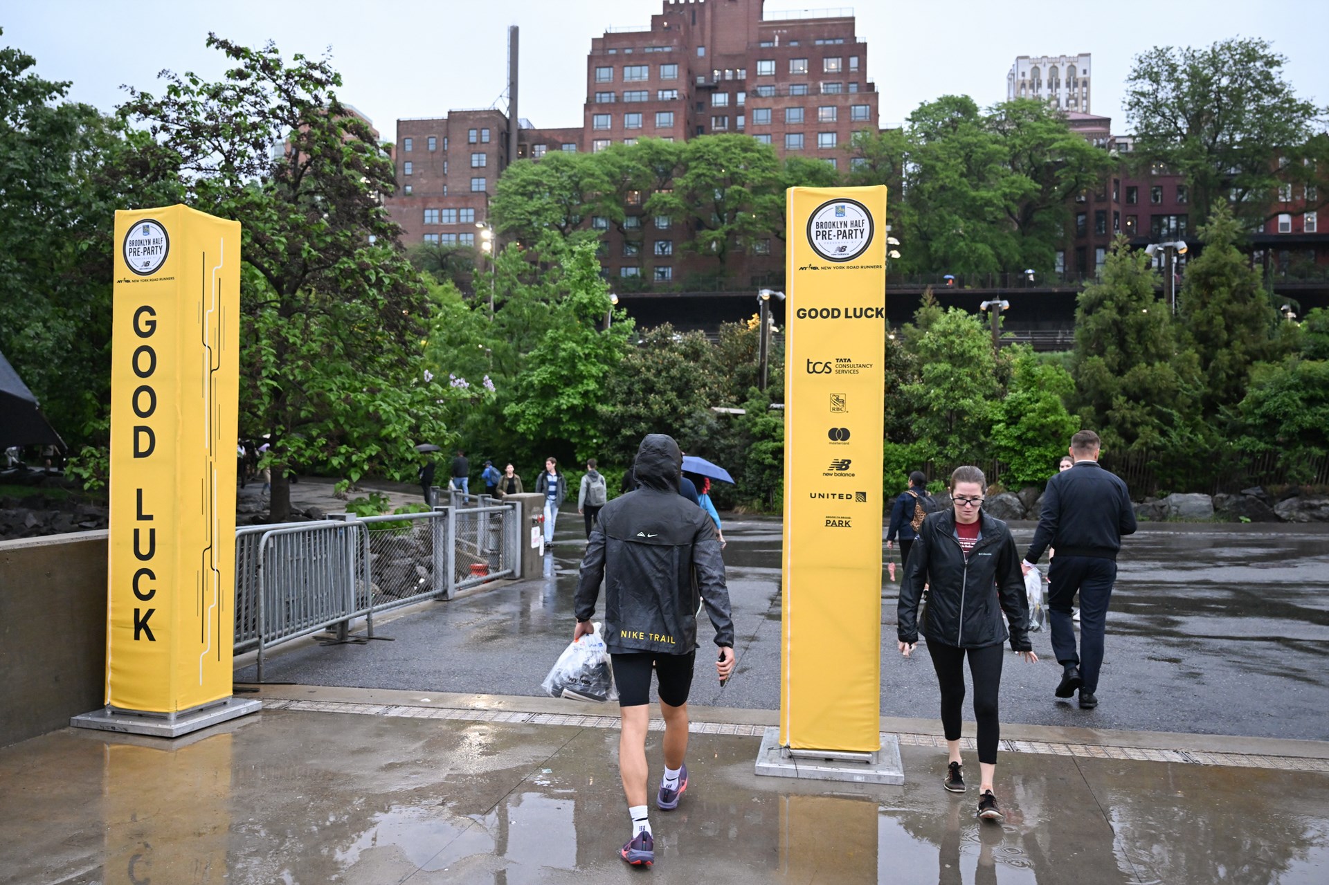 People coming and leaving the 2025 RBC Brooklyn Half Pre-Party at Pier 2