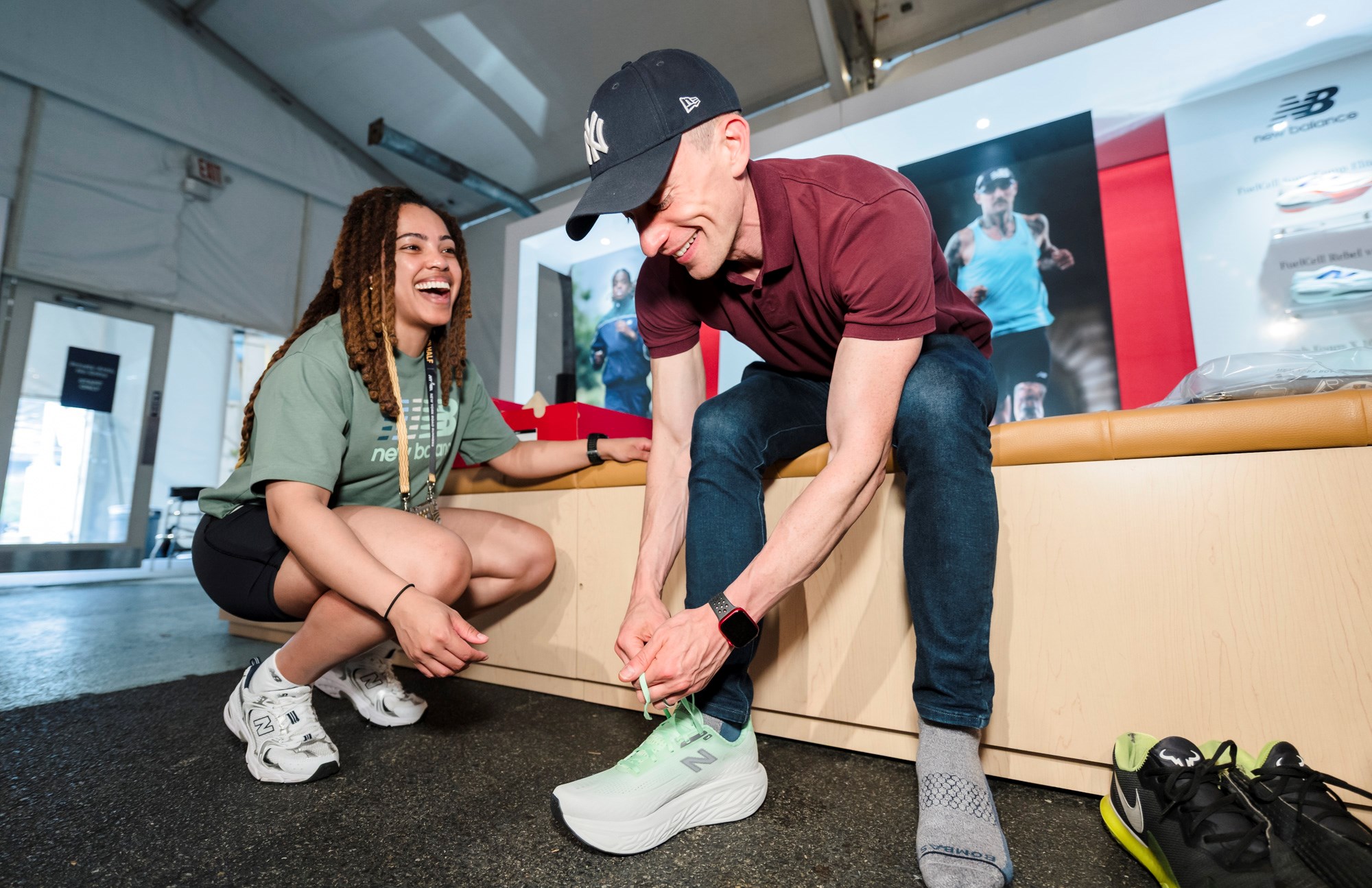 A man tries on New Balance sneakers at the 2025 RBC Brooklyn Half Pre-Party