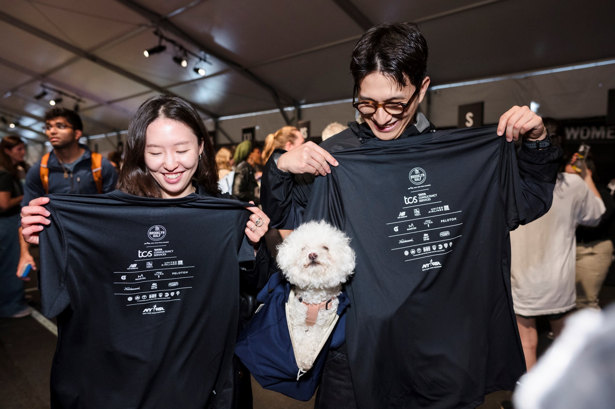 Two runners look at their RBC Brooklyn Half t-shirts at the 2025 RBC Brooklyn Half Pre-Party