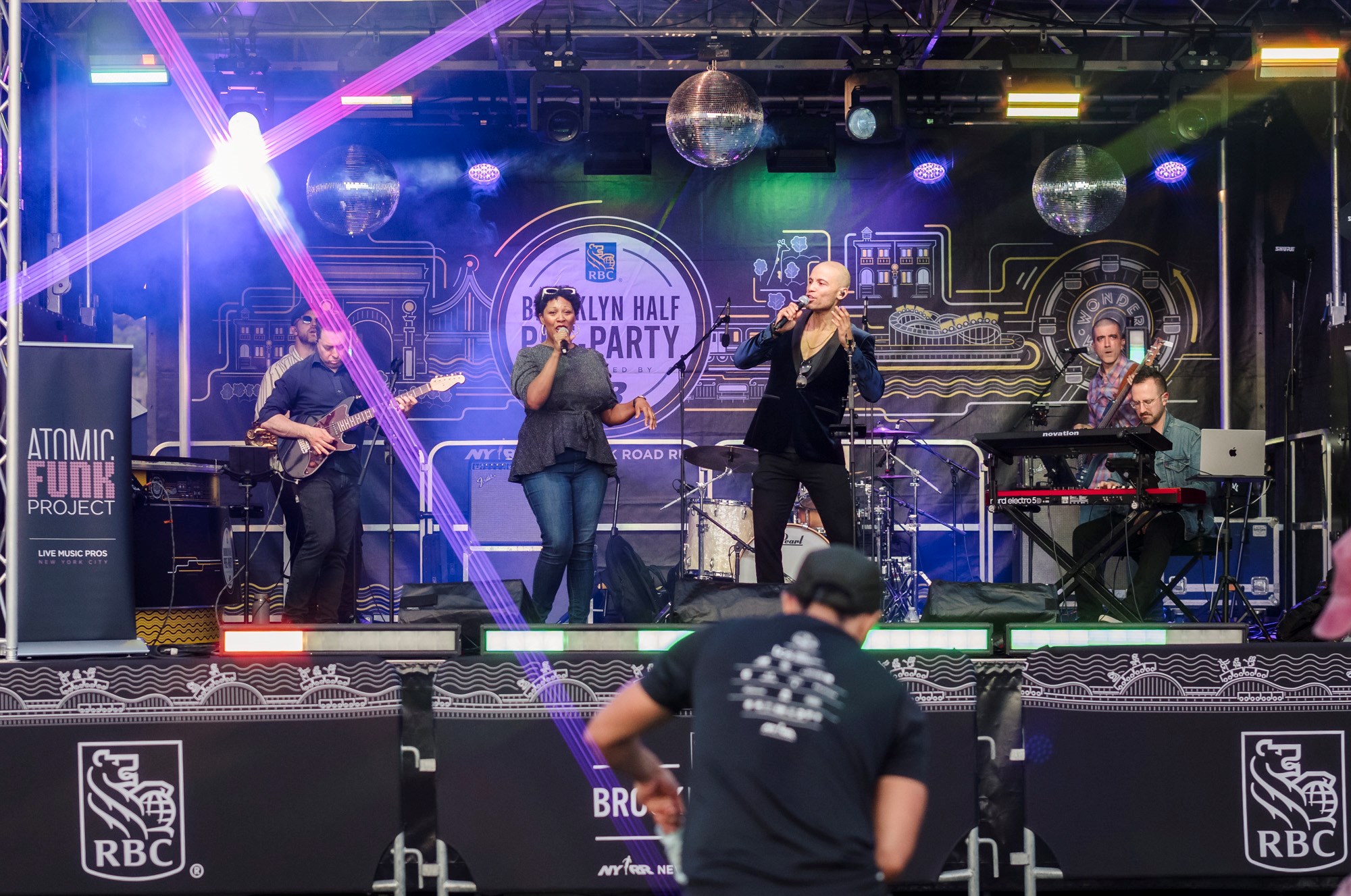 Two singers perform on stage at the 2025 RBC Brooklyn Half Pre-Party