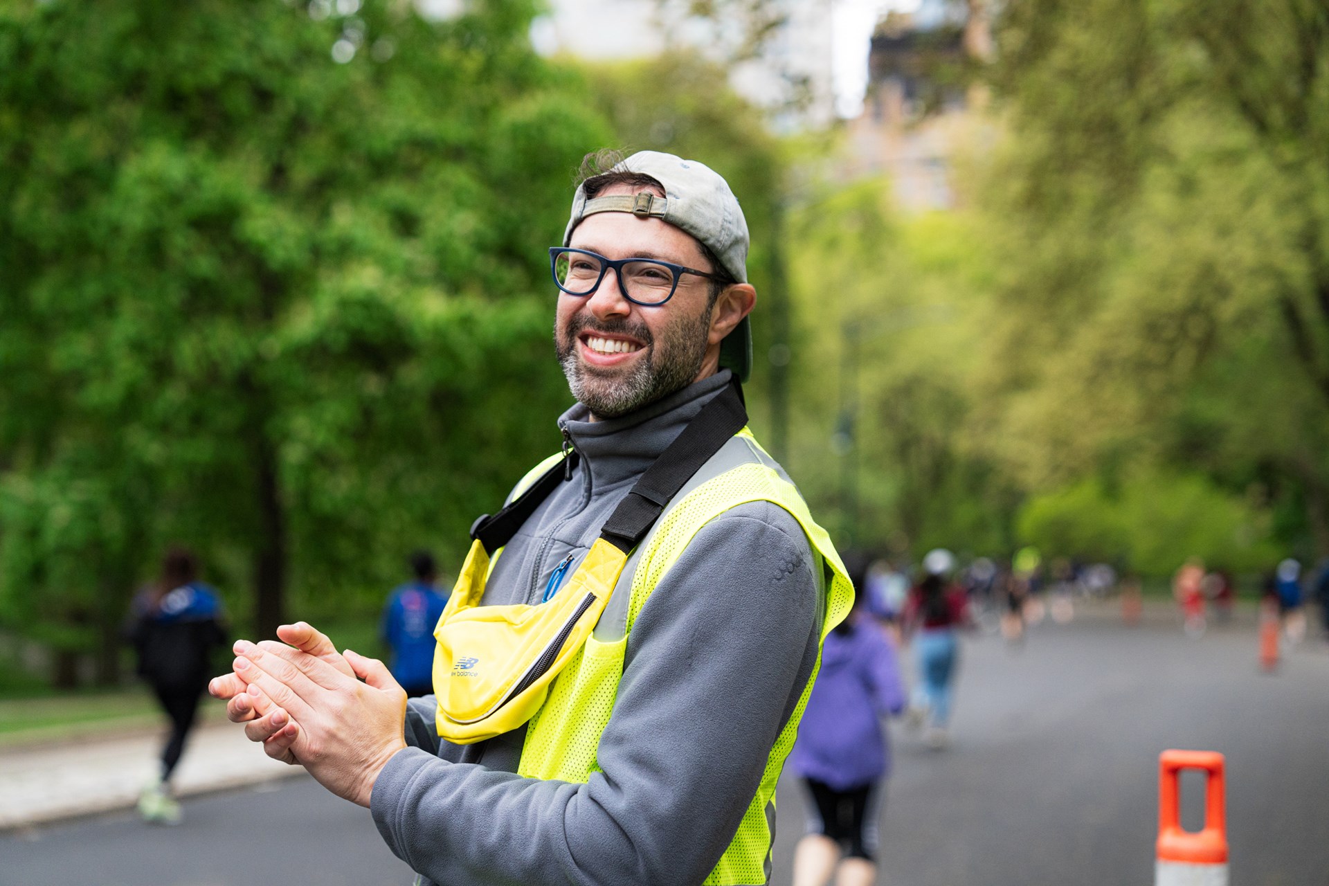 Volunteer cheering on runners in Central Park