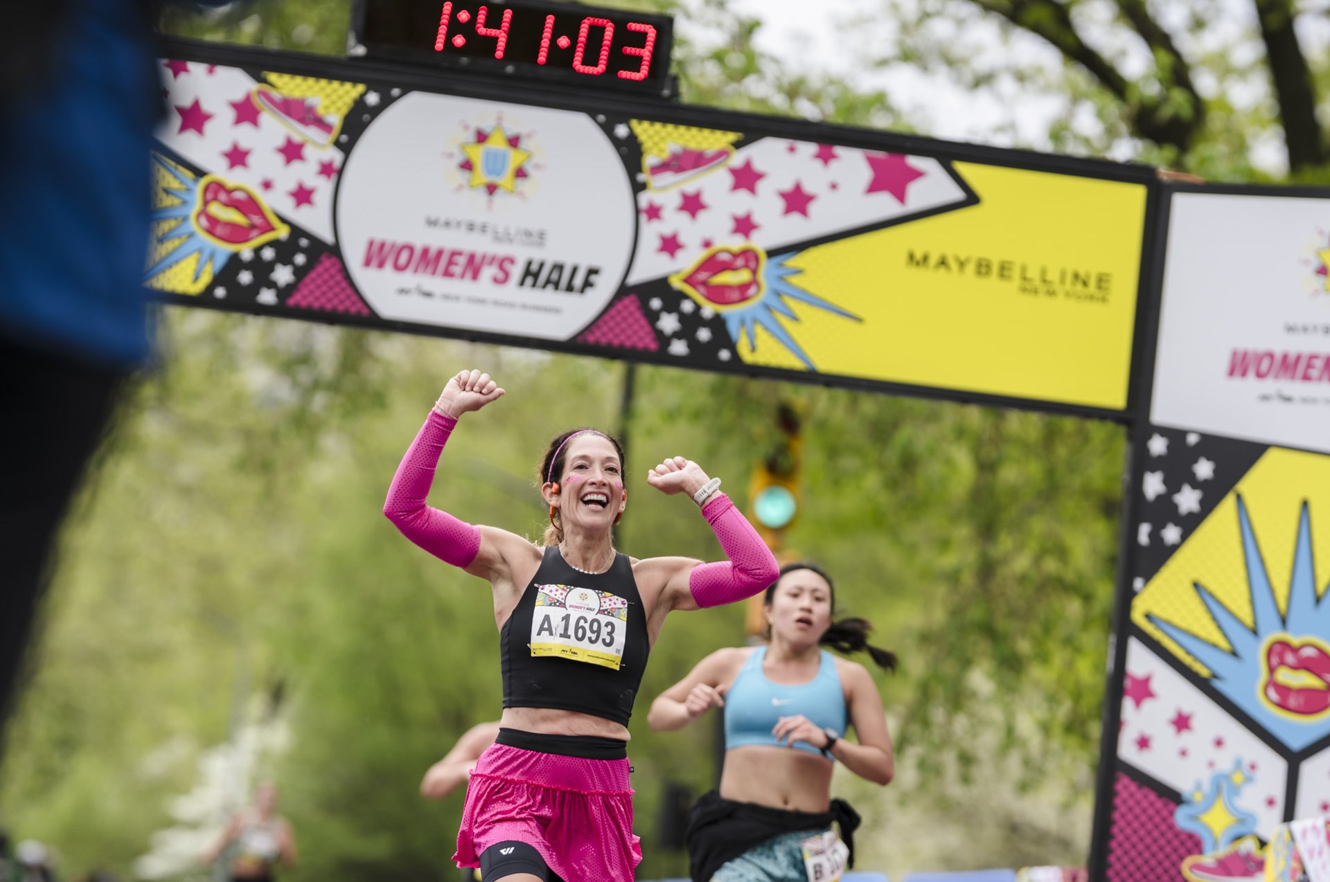 Runners cross the finish line at the Maybelline Women's Half in Central Park