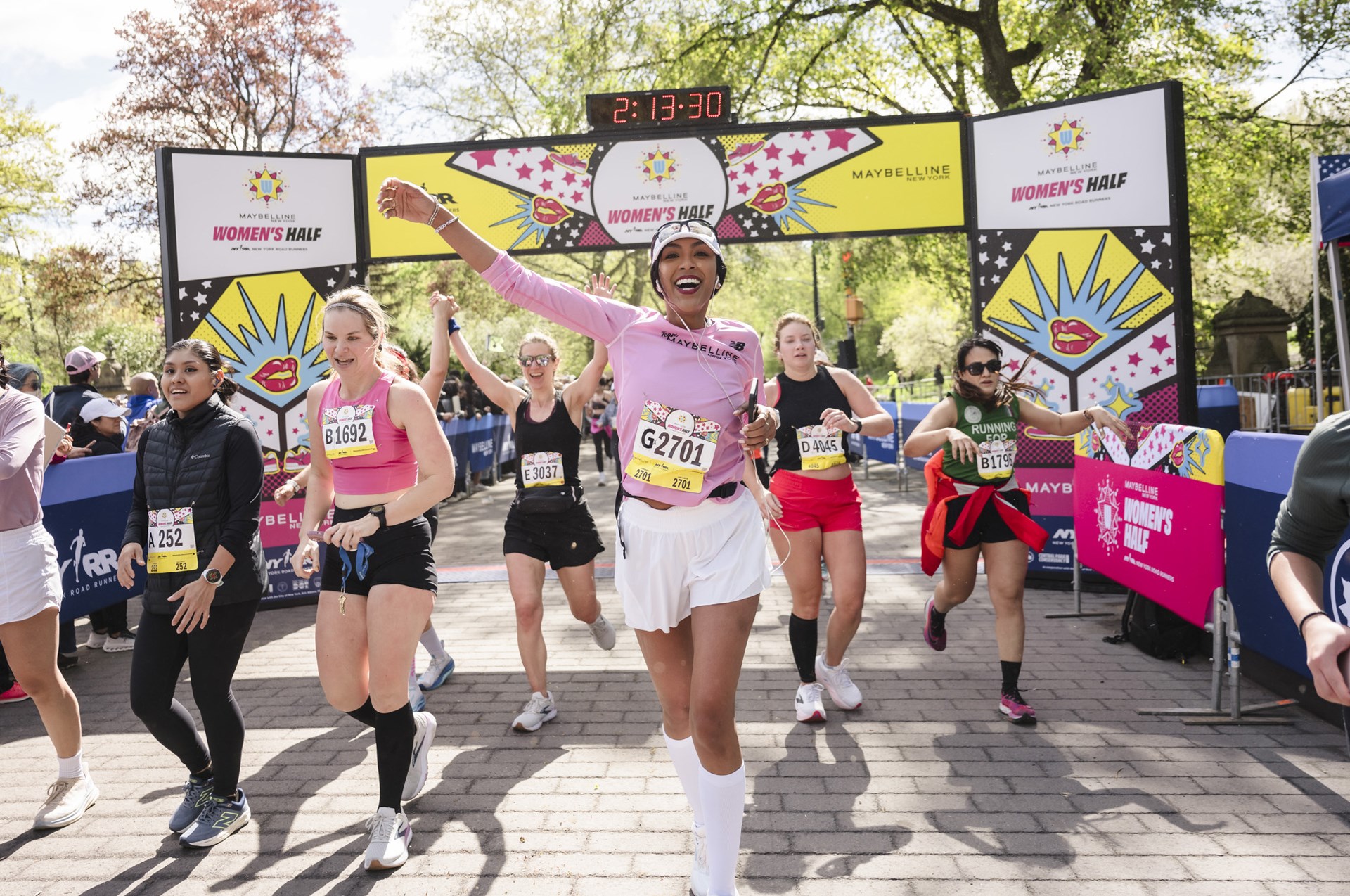 Runners cross the finish line at the Maybelline Women's Half in Central Park