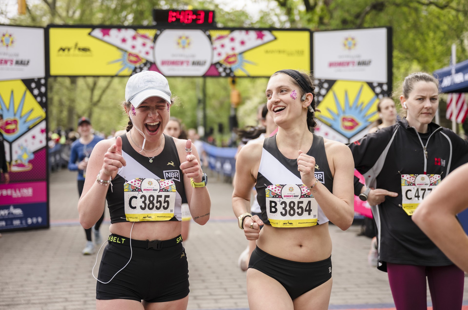 Runners cross the finish line at the Maybelline Women's Half in Central Park