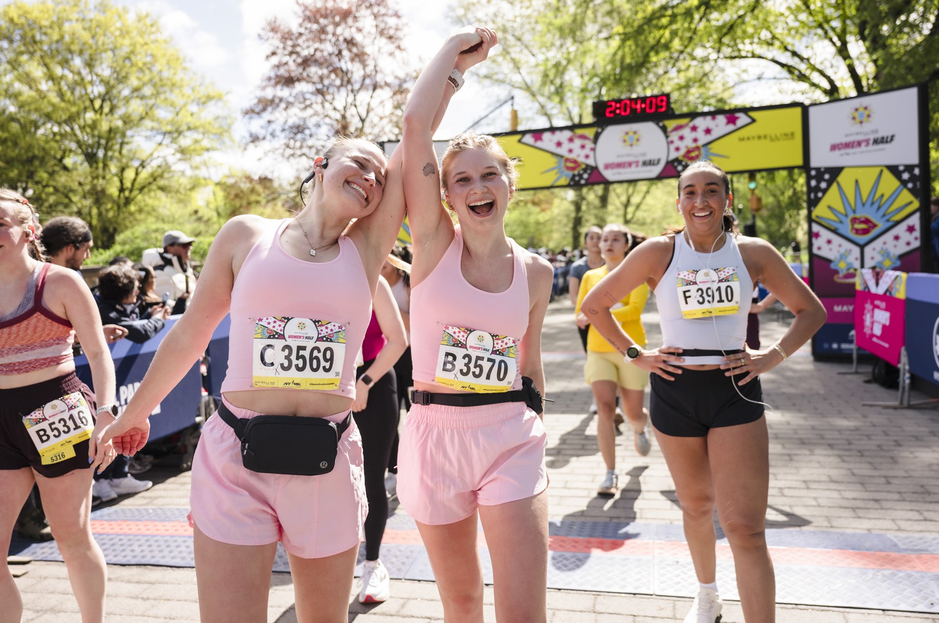 Runners cross the finish line at the Maybelline Women's Half in Central Park