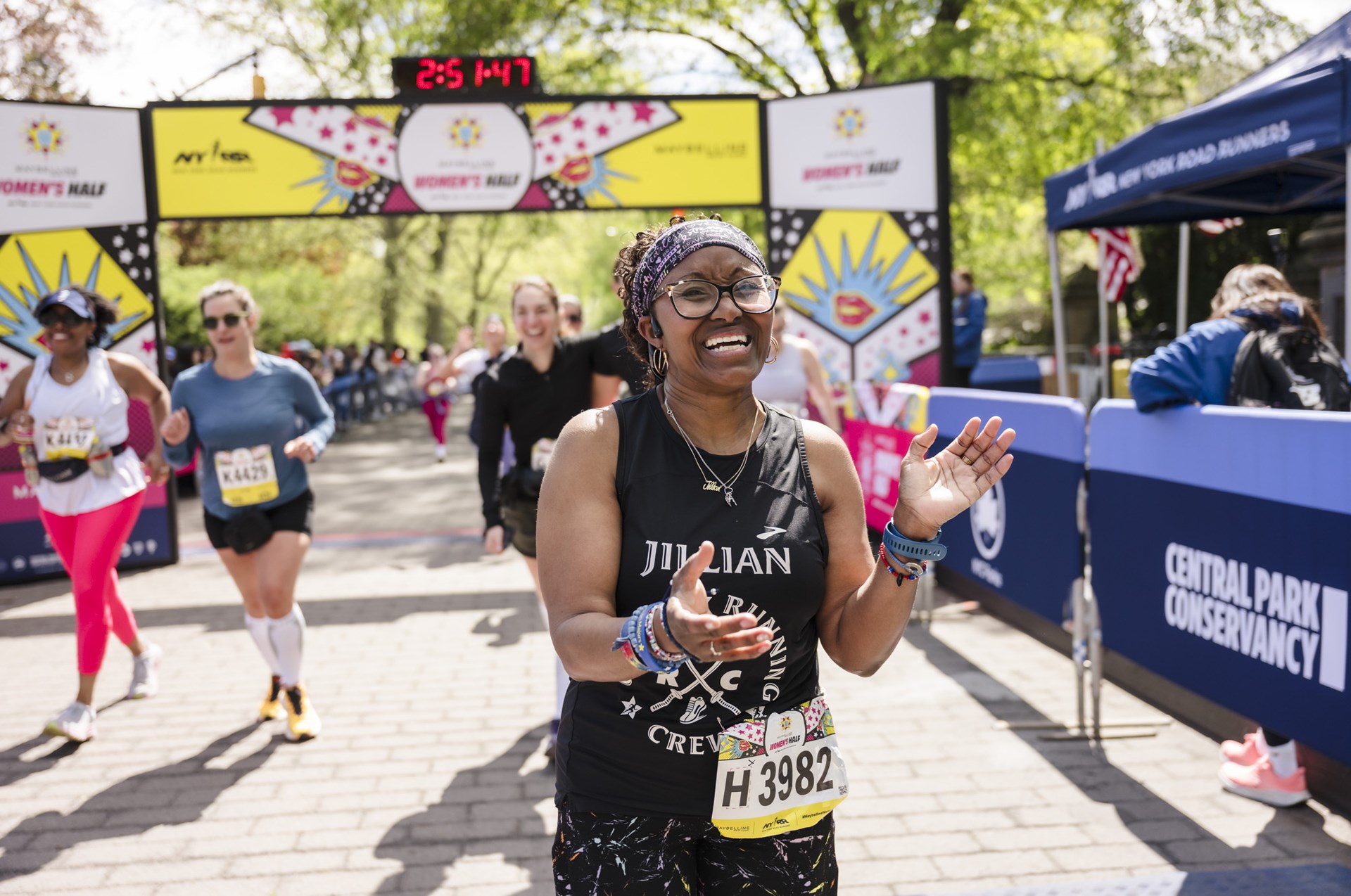 Runners cross the finish line at the Maybelline Women's Half in Central Park