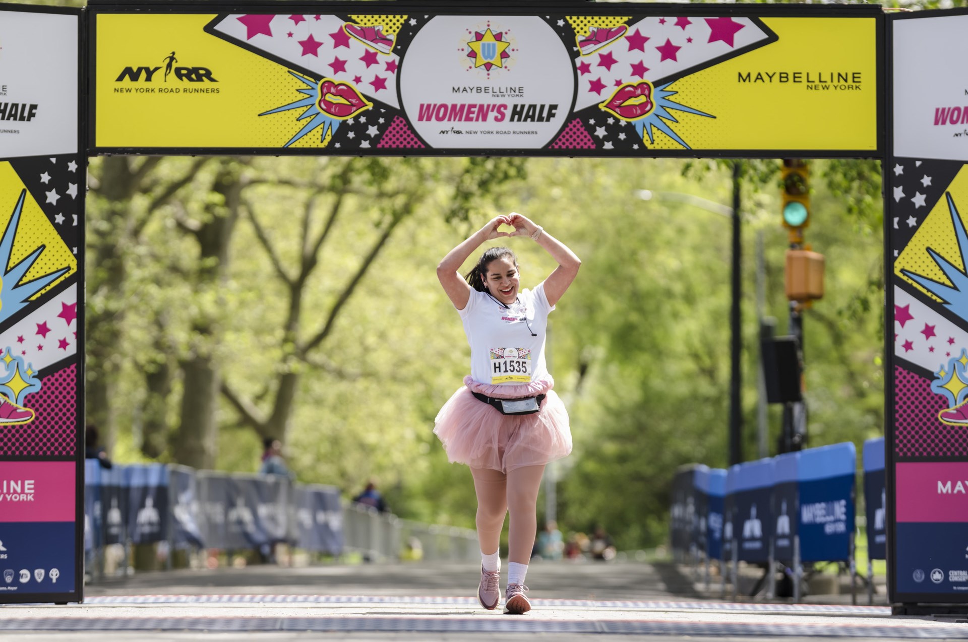 Runners cross the finish line at the Maybelline Women's Half in Central Park