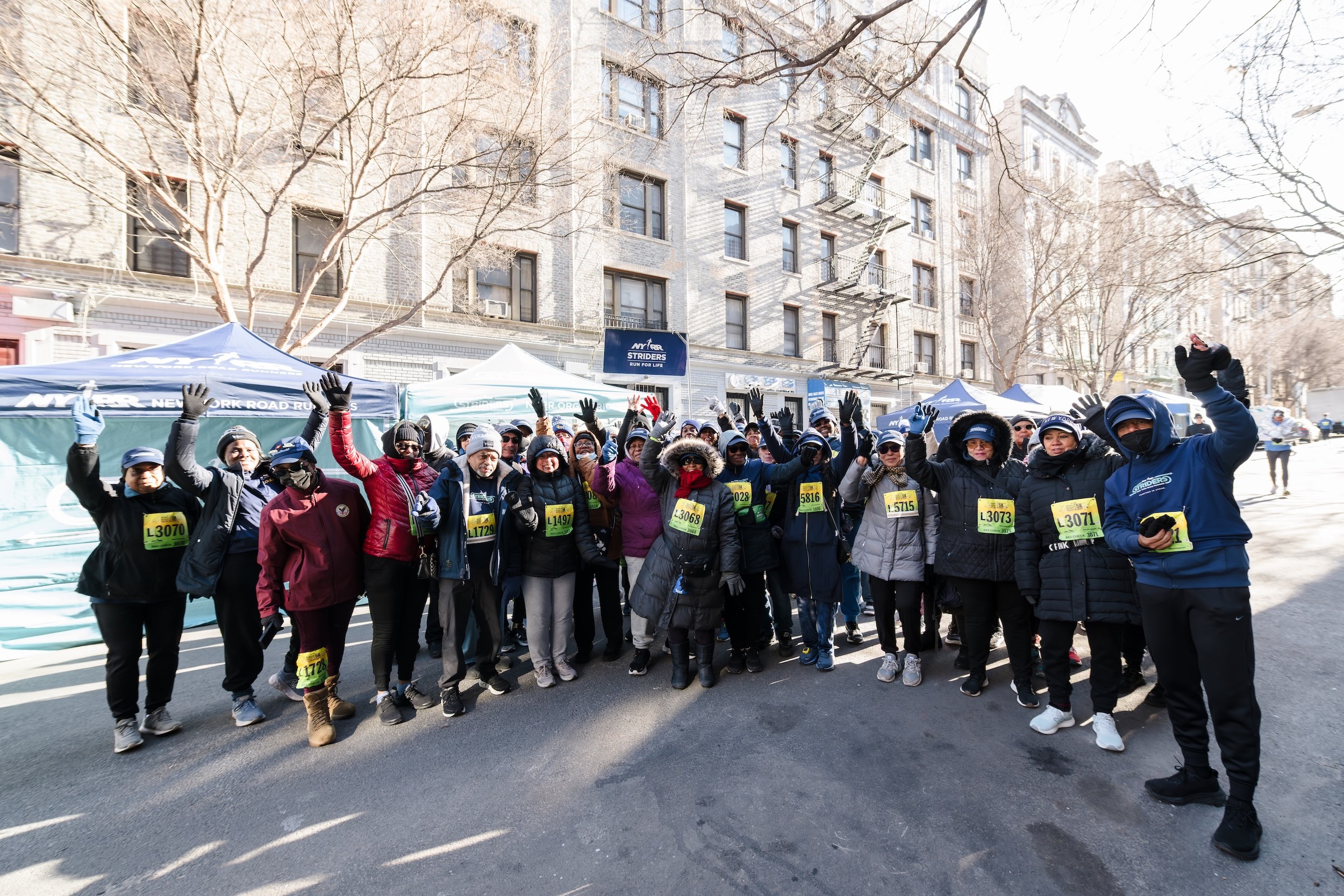 Striders cheering on the streets of Washington Heights
