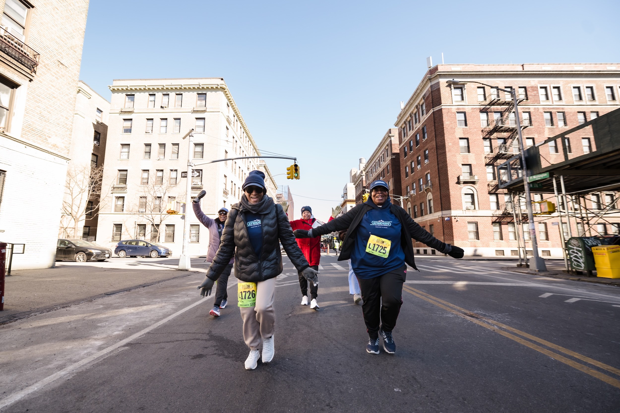Striders cheering on the streets of Washington Heights