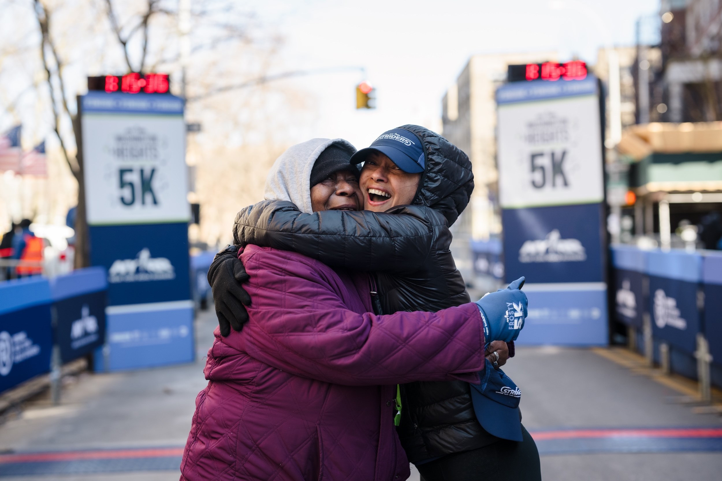 Striders hugging at the finish line