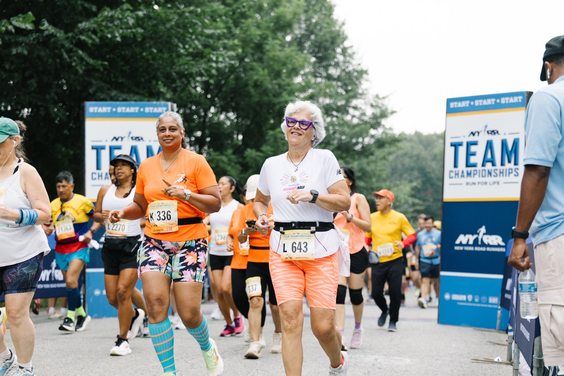 2 runners smiling at the starting line