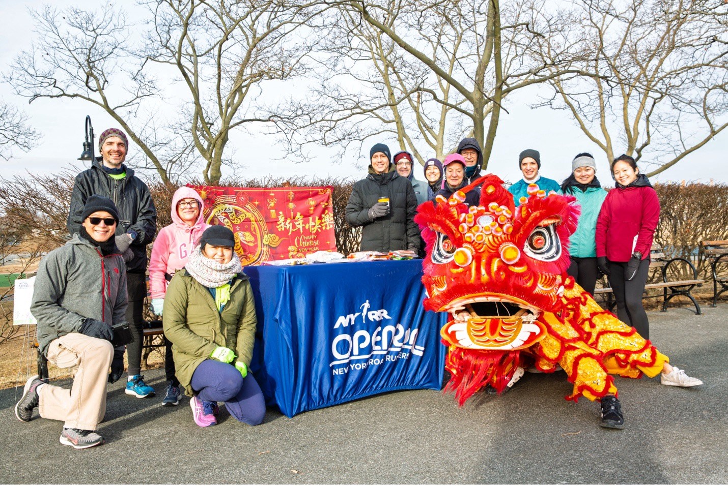 Group photo of runners with lion dance performer at Lunar New Year Open Run