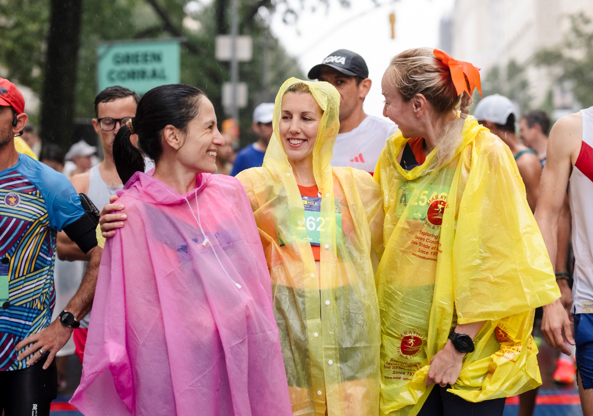Runners with rain ponchos at the New Balance 5th Avenue Mile course