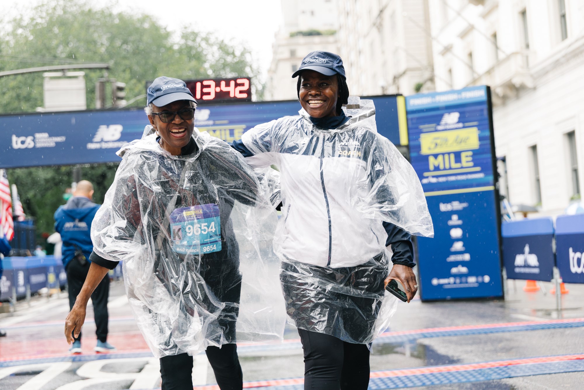 Strider with coach at the New Balance 5th Avenue Mile finish line.