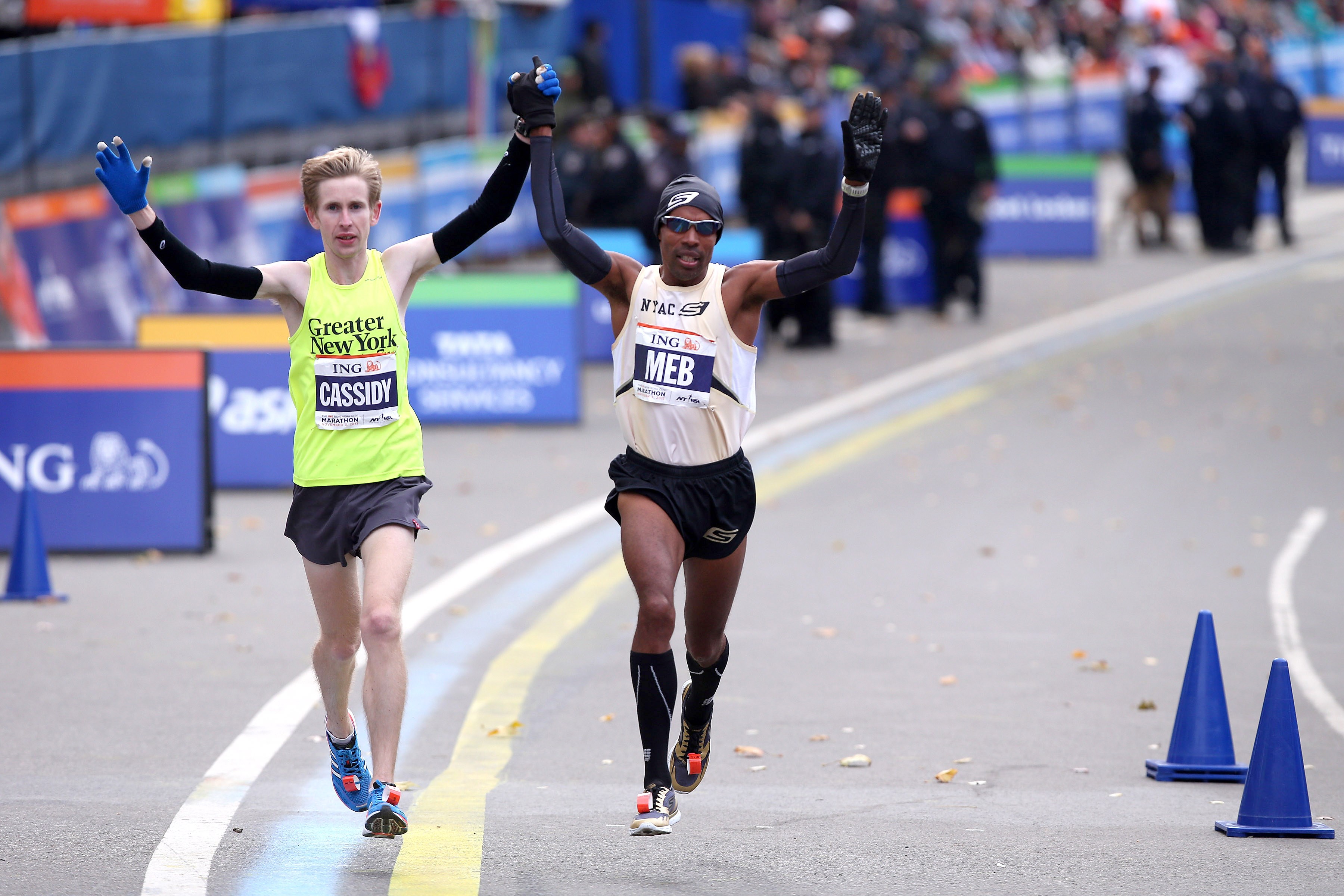 Meb Keflezighi and Mike Cassidy crossing finish line of 2013 TCS New York City Marathon