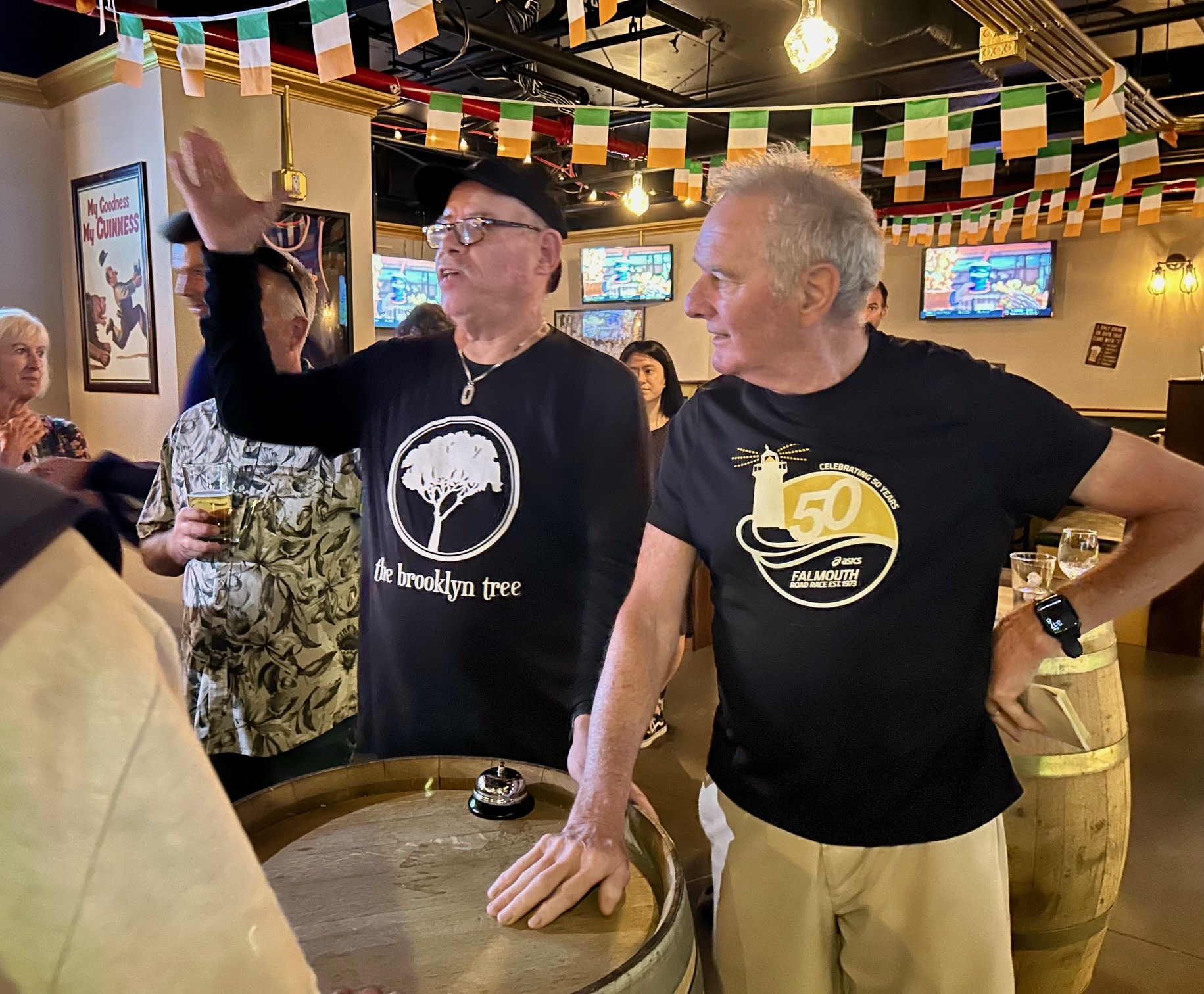Two older men runners at an Irish bar in Manhattan in September 2025.