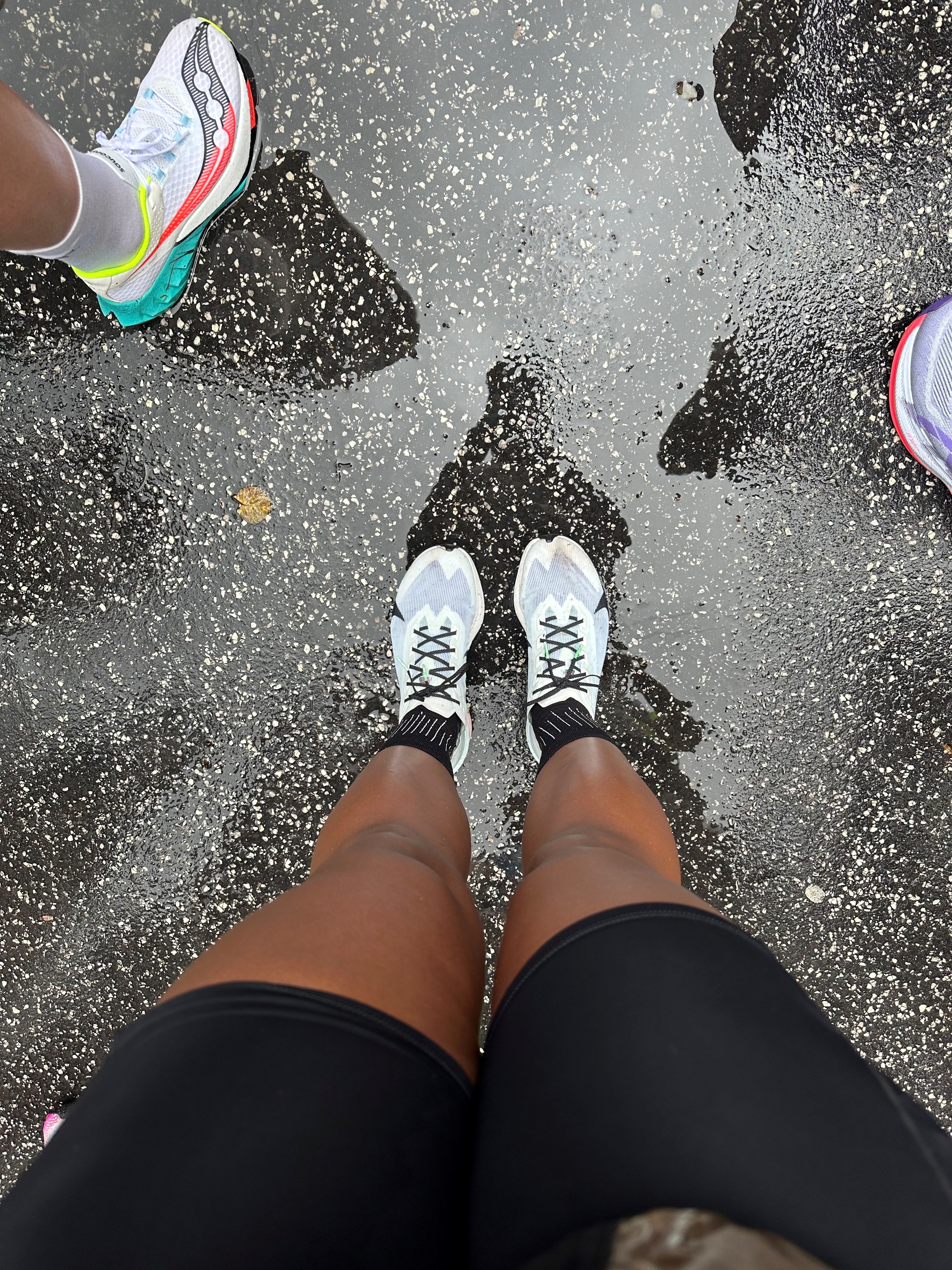 Victoria Fortune's legs and feet in the rain at the start of the 2025 Copenhagen Half Marathon.