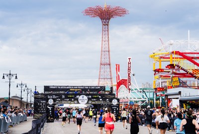RBC Brooklyn Half runners approaching the finish line on the Coney Island boardwalk. 