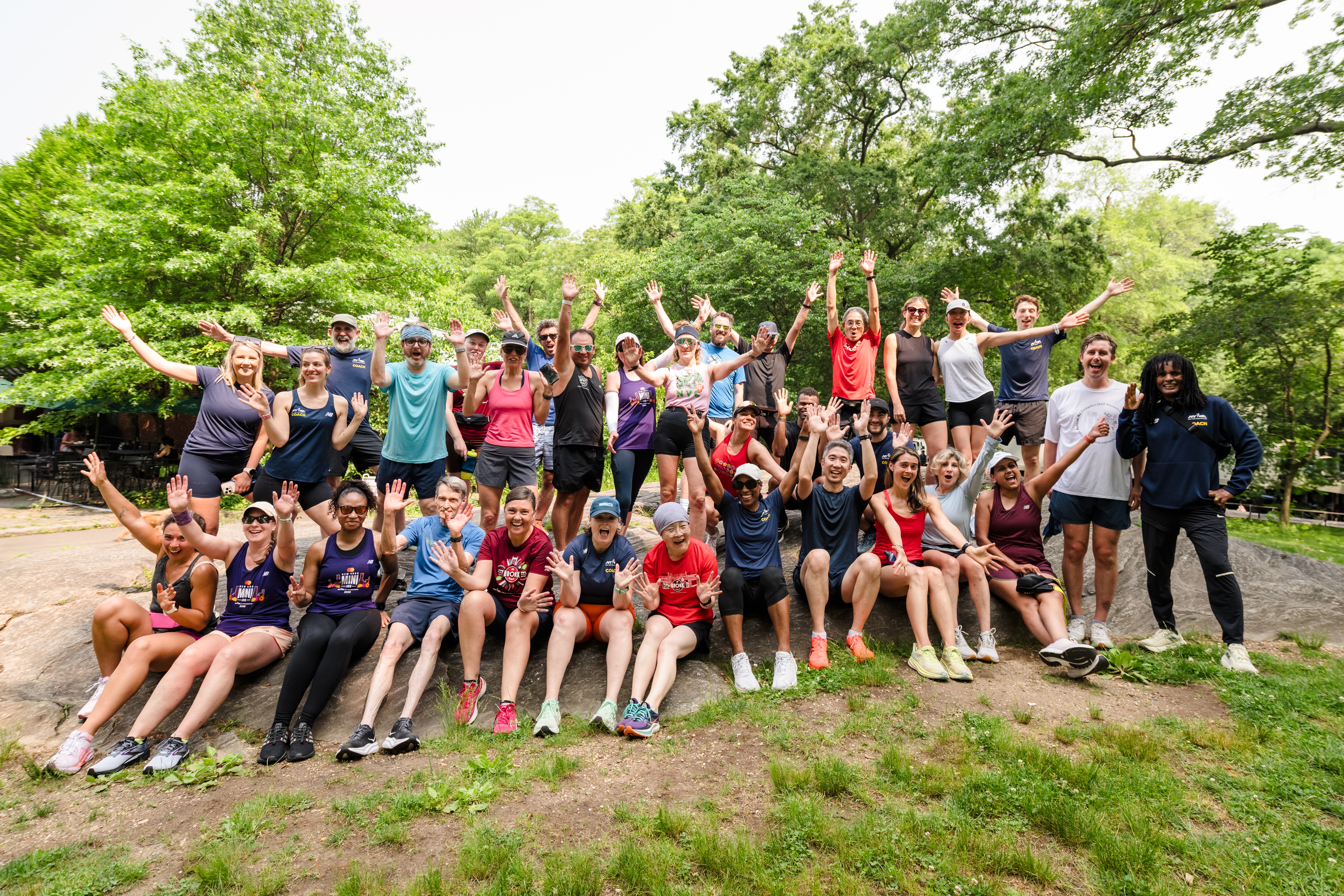 Group Training runners post-workout ona rock in Central Park in summer 2025