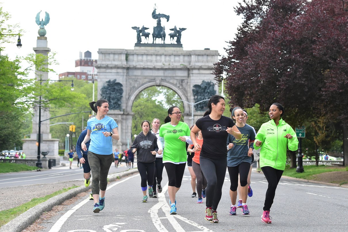 NYRR Group Training runners and coaches Prospect Park with Grand Army Plaza background