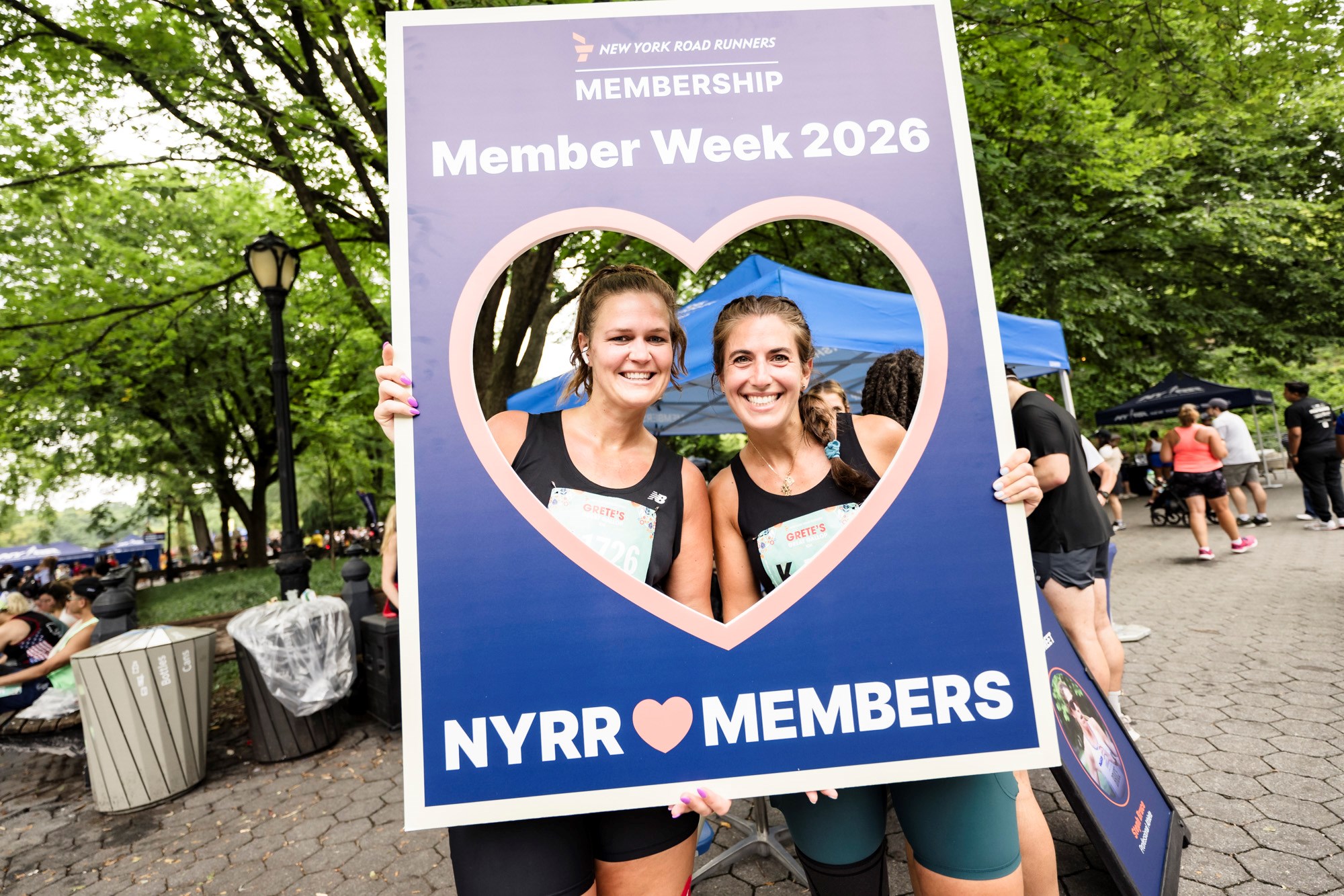 Runners at Grete's Great Gallop holding up Member Week sign