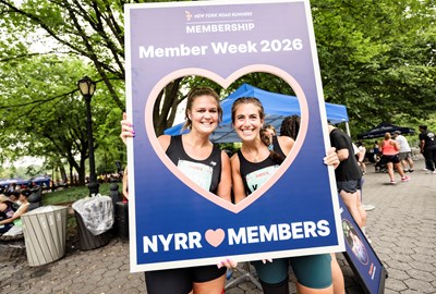 Runners at Grete's Great Gallop holding up Member Week sign