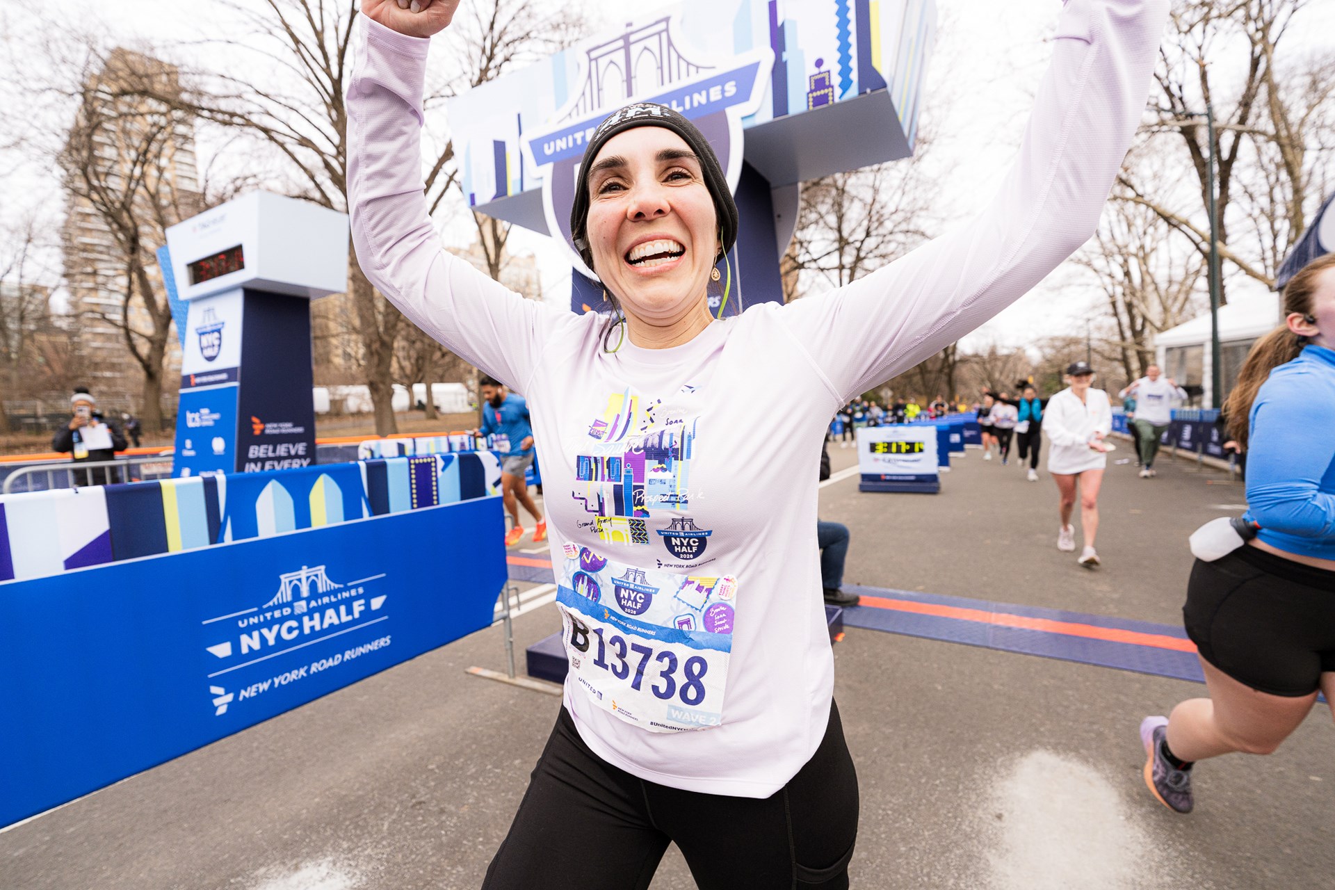 Women runner crossing finish line of 2026 United Airlines NYC Half