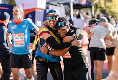 Two men hugging after finishing the 2025 TCS New York City Marathon.