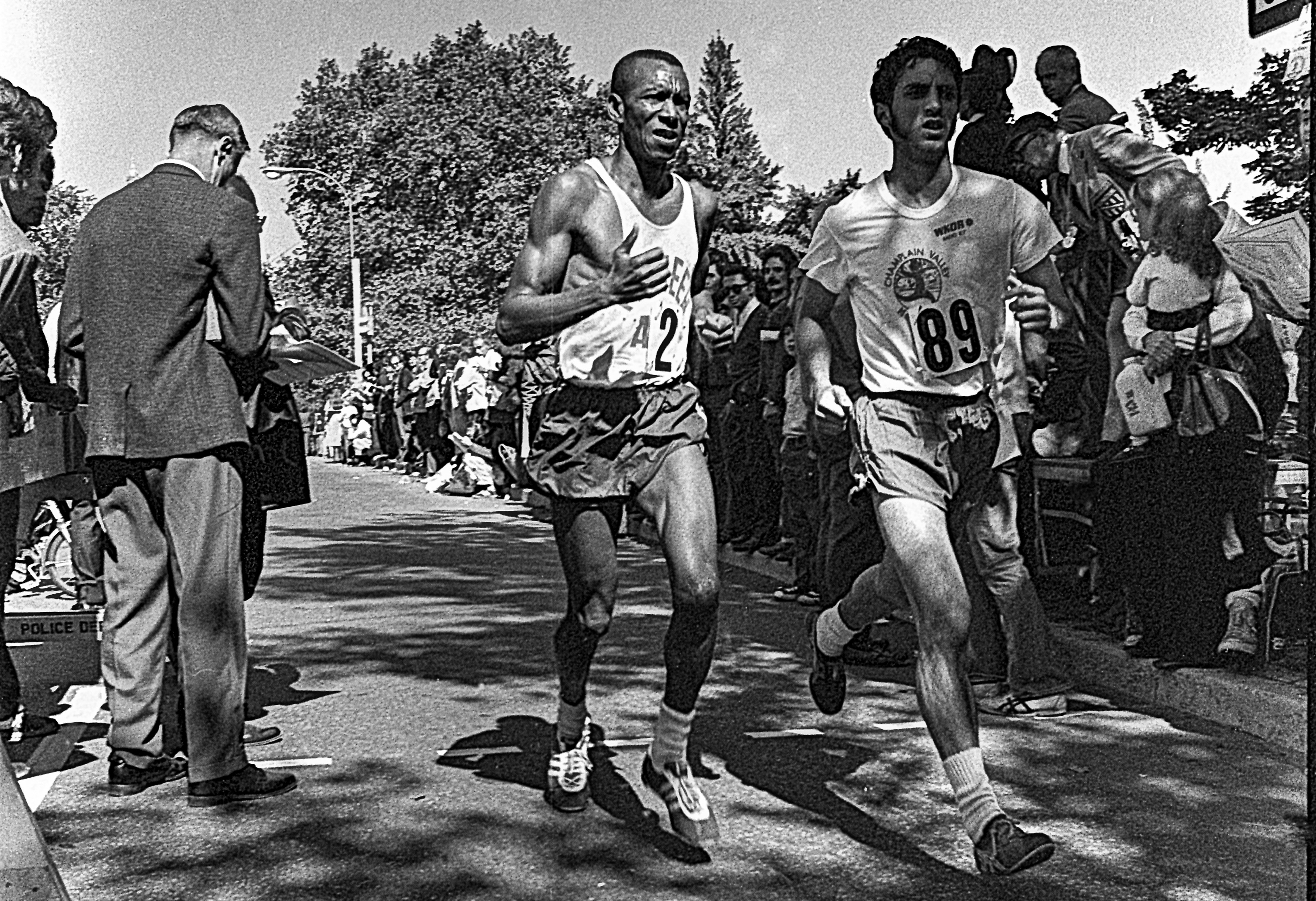 Black and white photo of Ted Corbitt and another competitor with spectators in the 1972 New York City Marathon