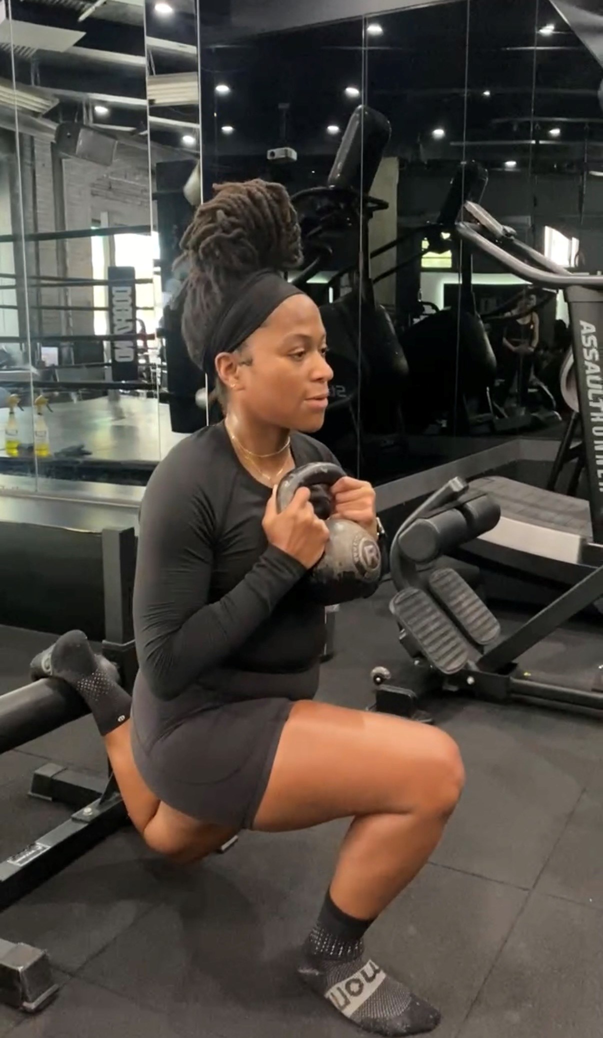 Victoria Fortune working out with weights at a gym.