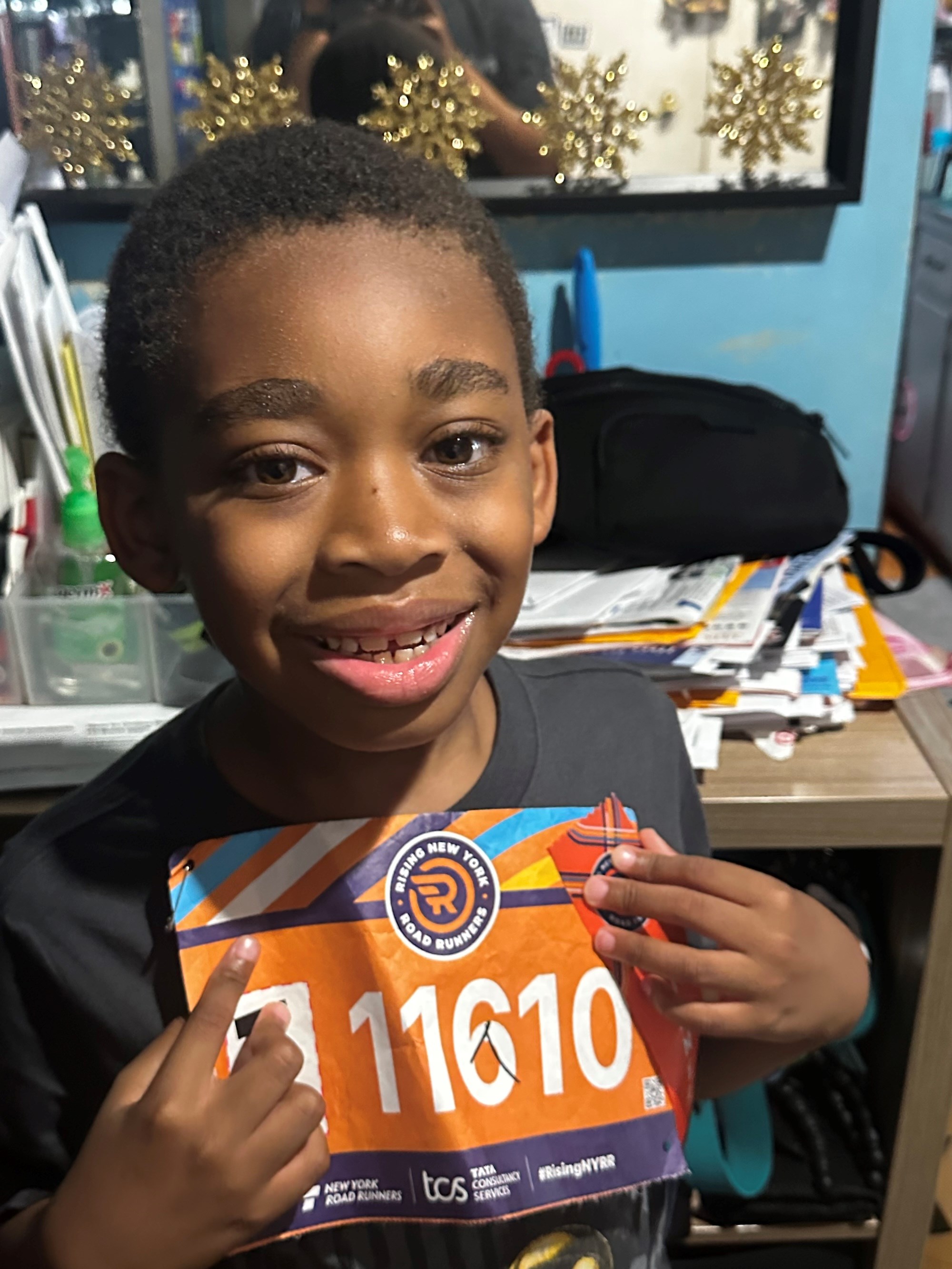 Omari showing his race bib 