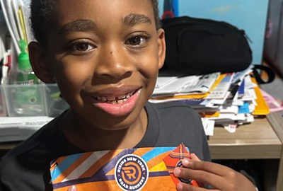 Omari showing his race bib 