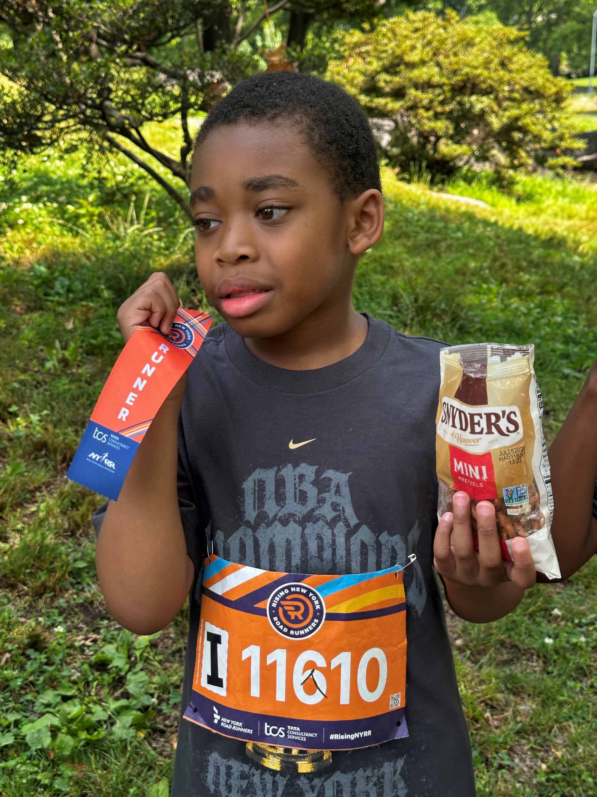 Omari with his ribbon and pretzels after the race