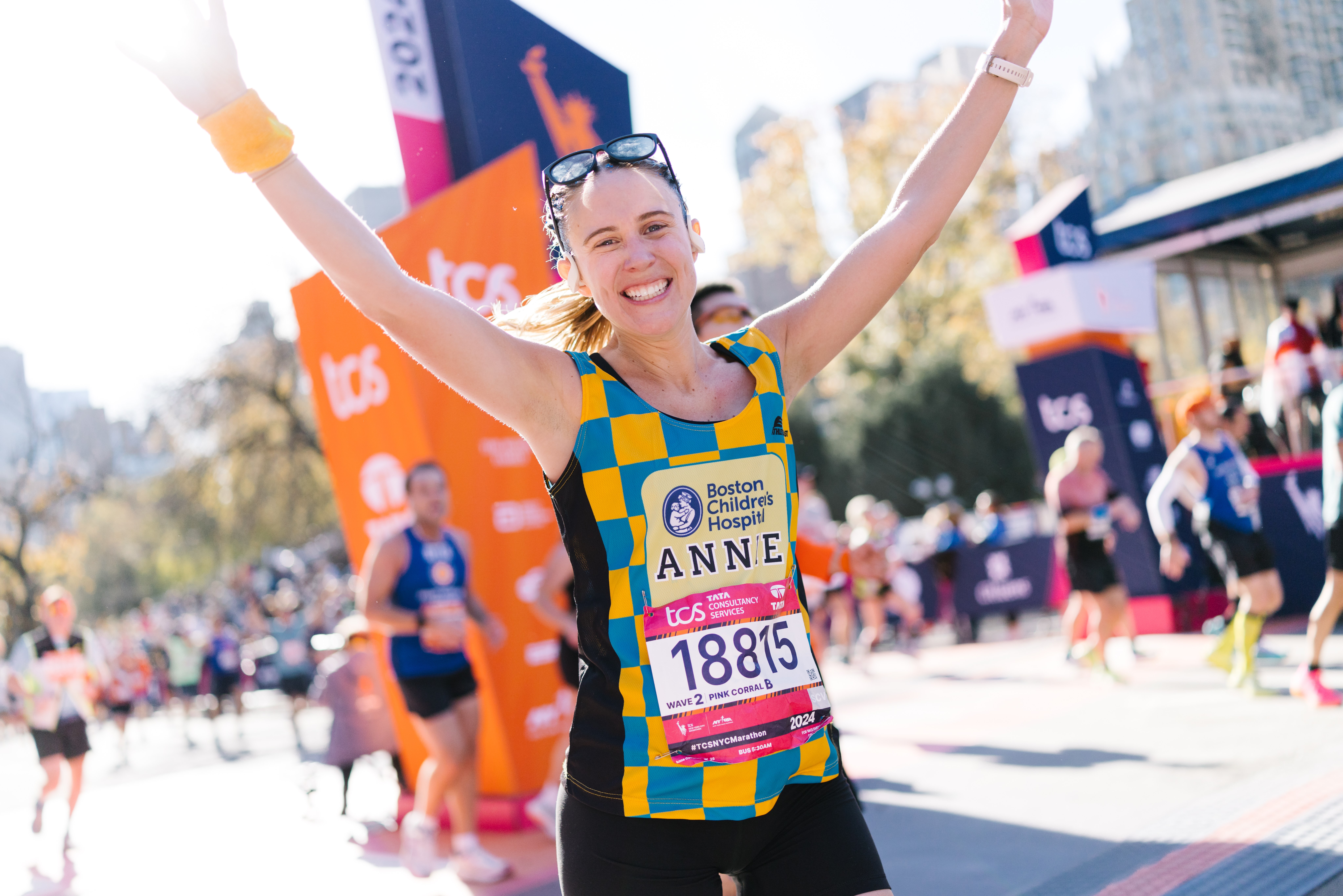 2024 TCS NYC Marathon finisher with arms raised